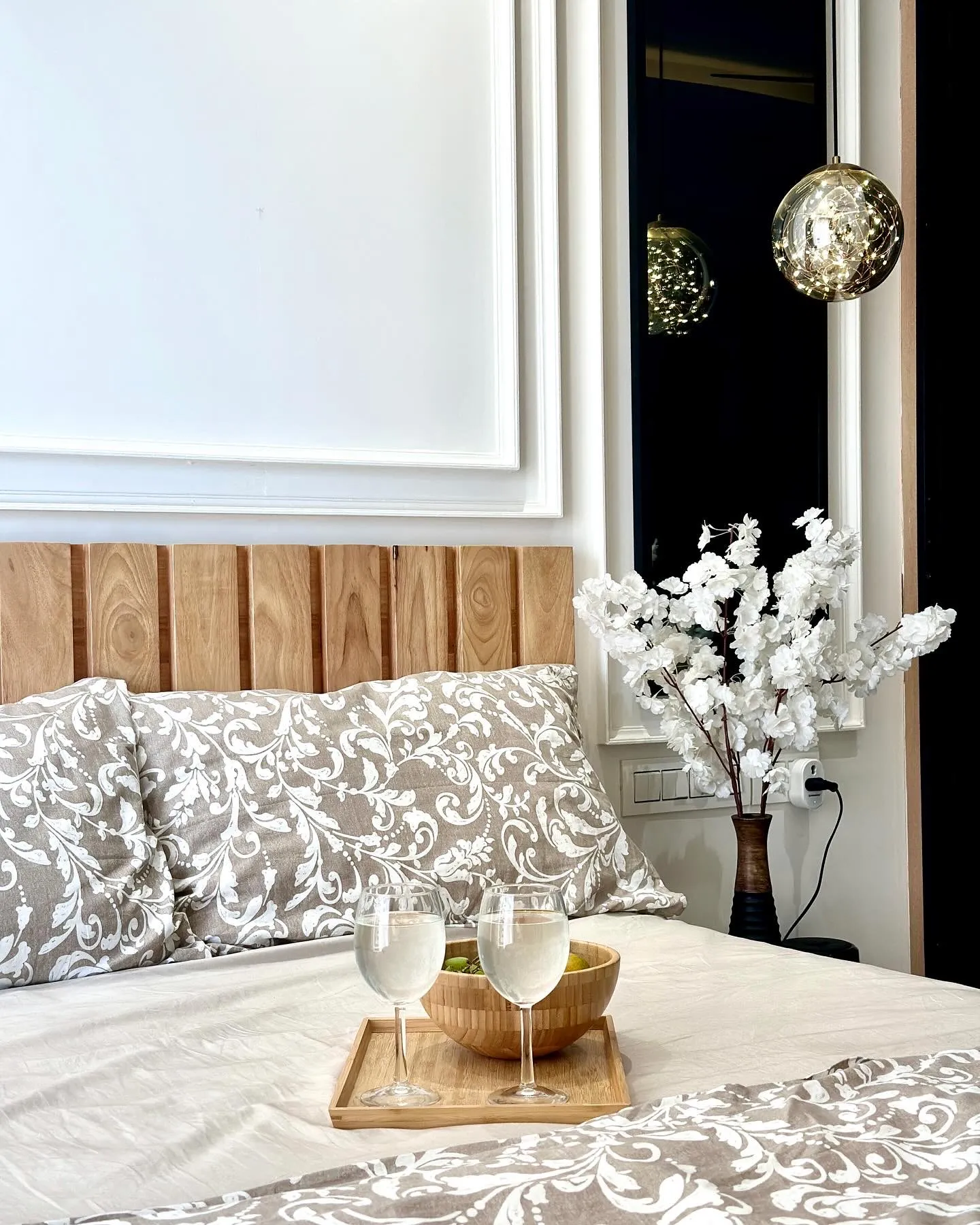 Bed with oak headboard and pendant light — The Aakar
